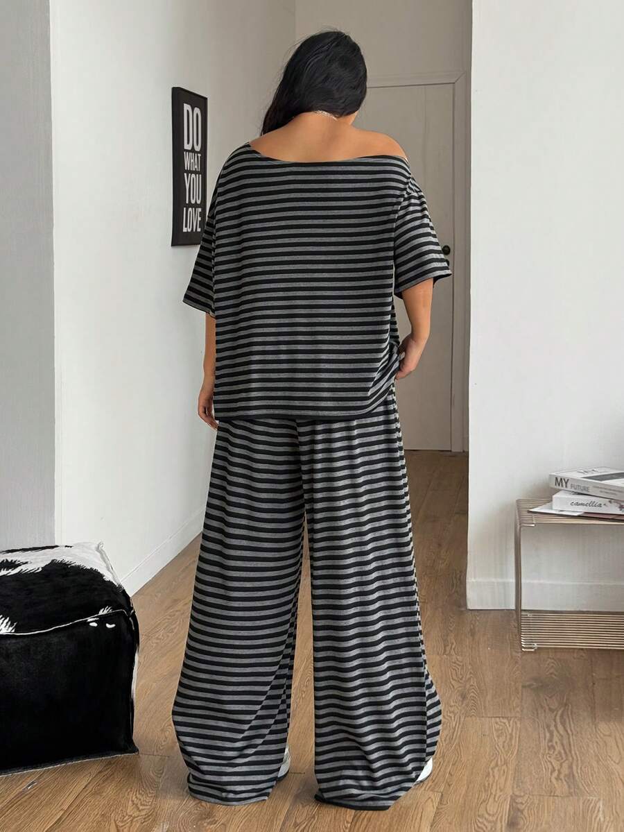 Women's casual two-piece outfit featuring a loose short-sleeve asymmetrical neck t-shirt and matching long wide leg pants with pockets.