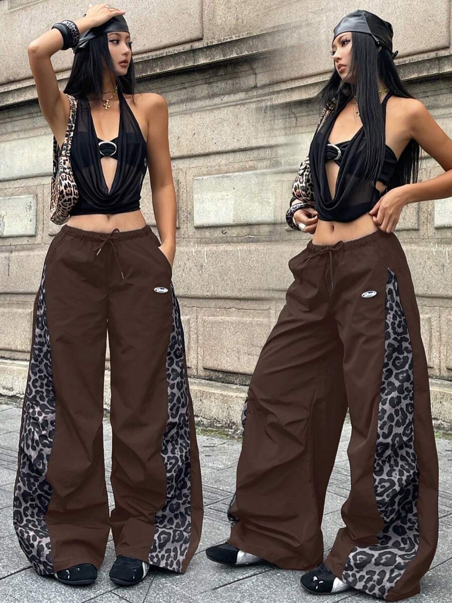 Women's black baggy jogger pants with an adjustable drawstring waist and colorblock polka dot geometric pattern.