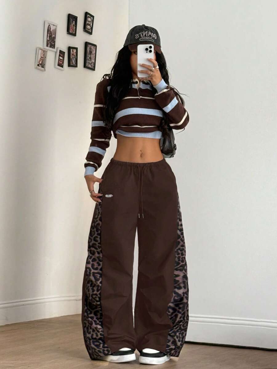 Women's black baggy jogger pants with an adjustable drawstring waist and colorblock polka dot geometric pattern.