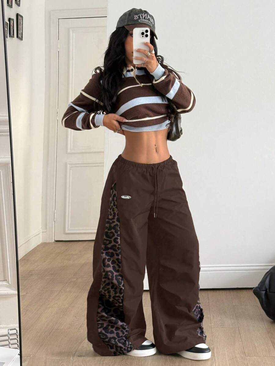 Women's black baggy jogger pants with an adjustable drawstring waist and colorblock polka dot geometric pattern.
