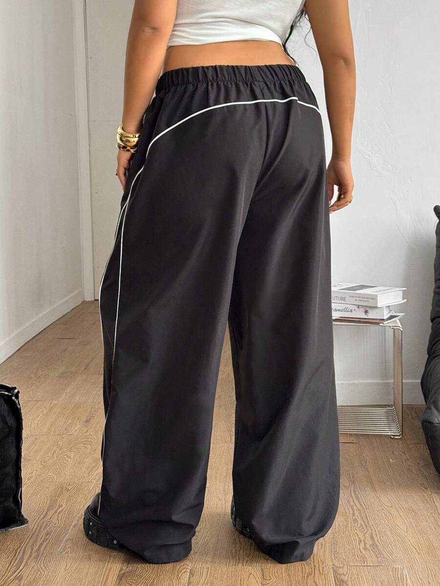 Plus size loose straight leg casual pants with elastic drawstring waist, contrast binding, and side pockets.