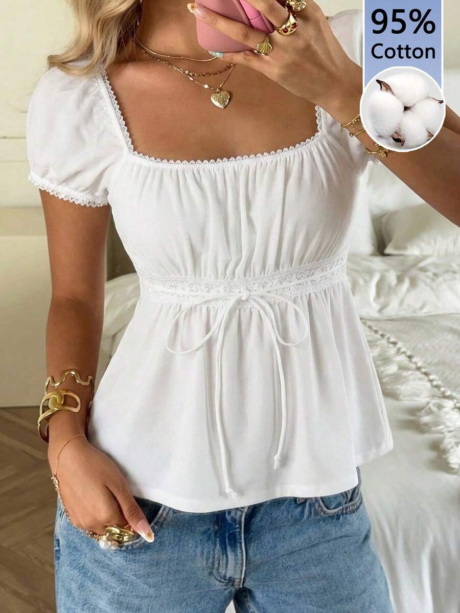 Women's black short puff sleeve top featuring a square neckline, ruched bust detail, and flared ruffle hem.