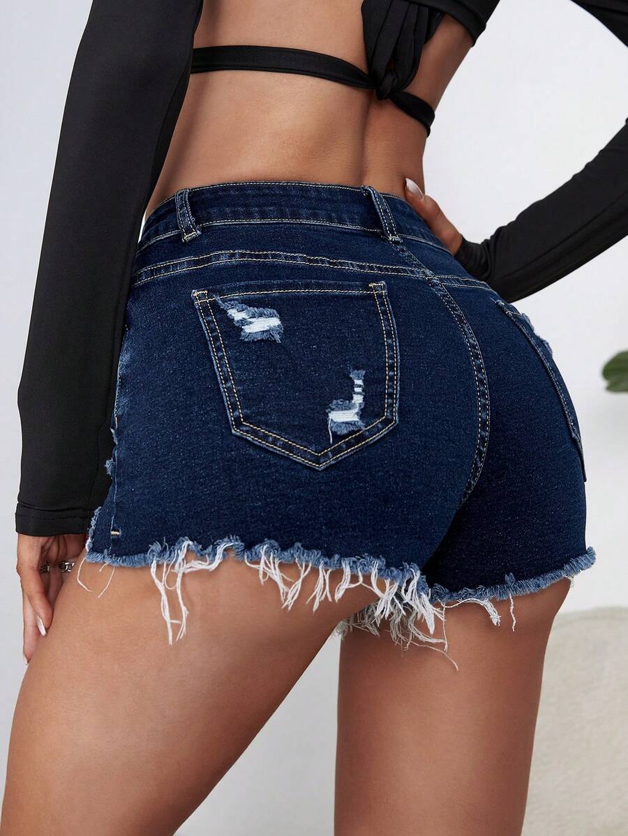 Women's solid color shorts with zipper fly, button closure, pockets, ripped details, and raw hem in a casual straight-leg short length