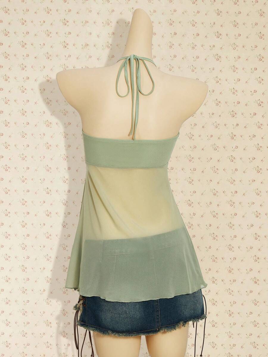 Women's boho halter mesh tank top with asymmetrical hem, semi-sheer finish, lined body, slim fit, and cold shoulder styling.