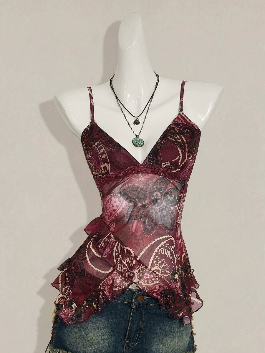 Women's graphic print camisole top featuring thin spaghetti straps, a backless cut, and an asymmetrical hem.