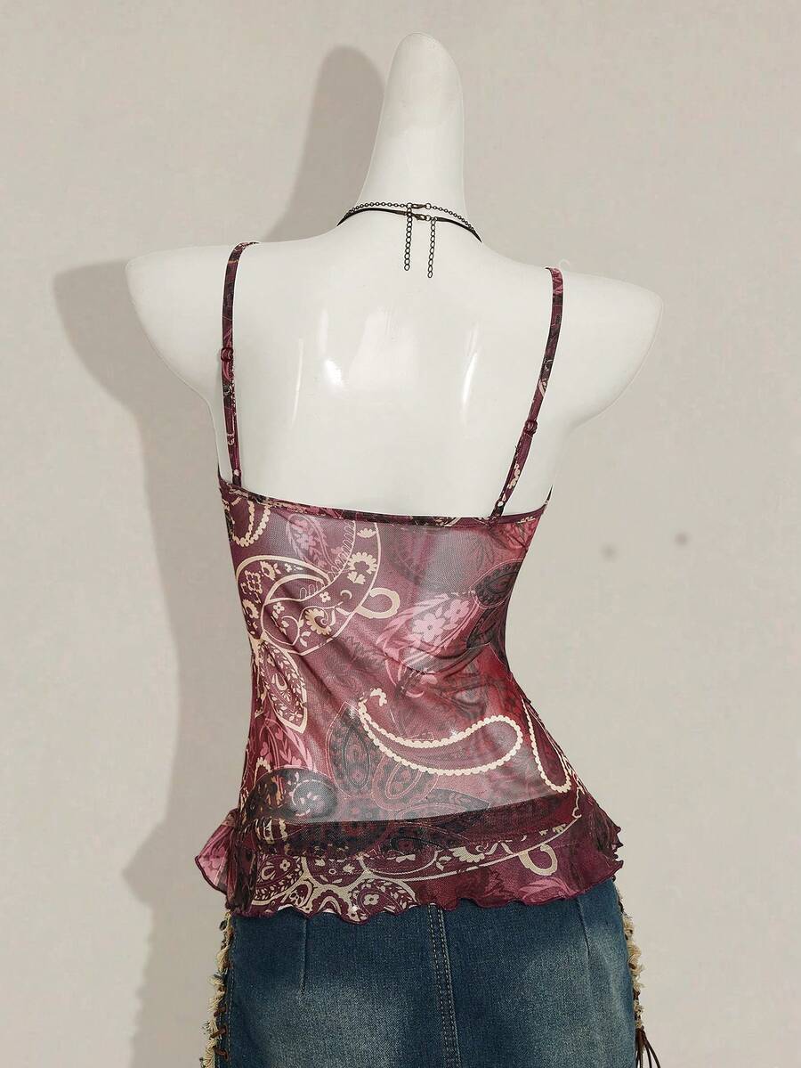 Women's graphic print camisole top featuring thin spaghetti straps, a backless cut, and an asymmetrical hem.