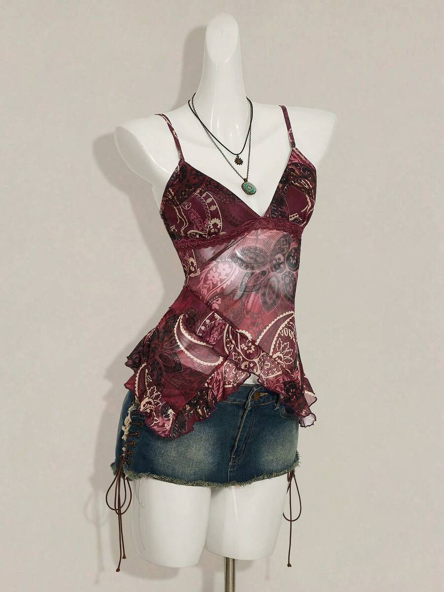 Women's graphic print camisole top featuring thin spaghetti straps, a backless cut, and an asymmetrical hem.