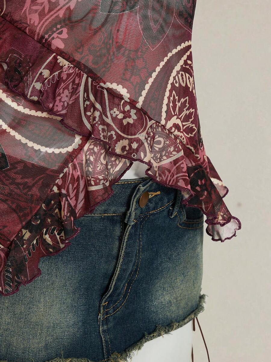 Women's graphic print camisole top featuring thin spaghetti straps, a backless cut, and an asymmetrical hem.