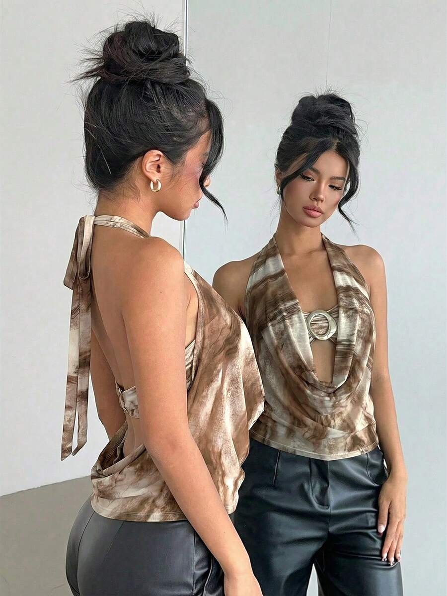 Brown and white polka dot semi-sheer halter camisole top with a plunging neckline, backless design, draped front, and metallic studded embellishments.