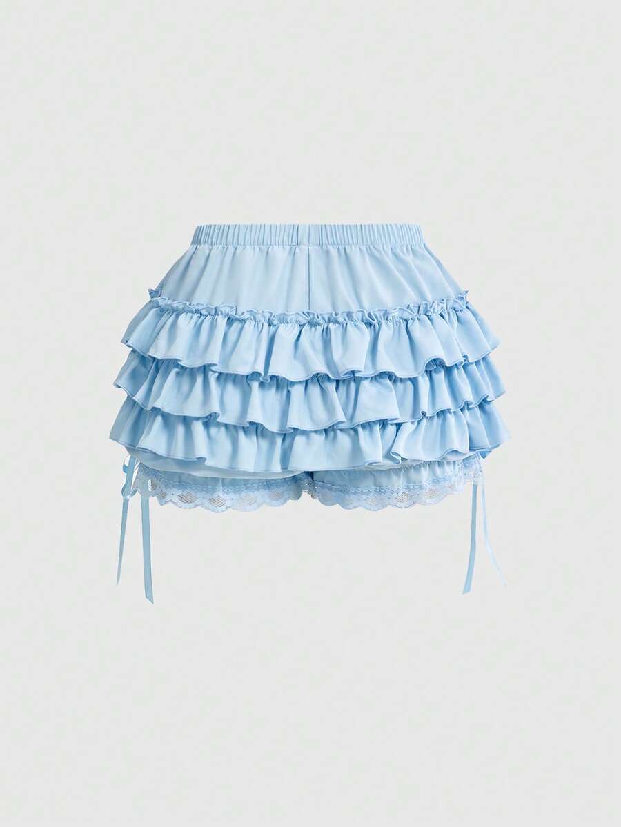 Women's tiered ruffle skort shorts featuring an elastic mid waist with front tie knot detail in woven fabric.