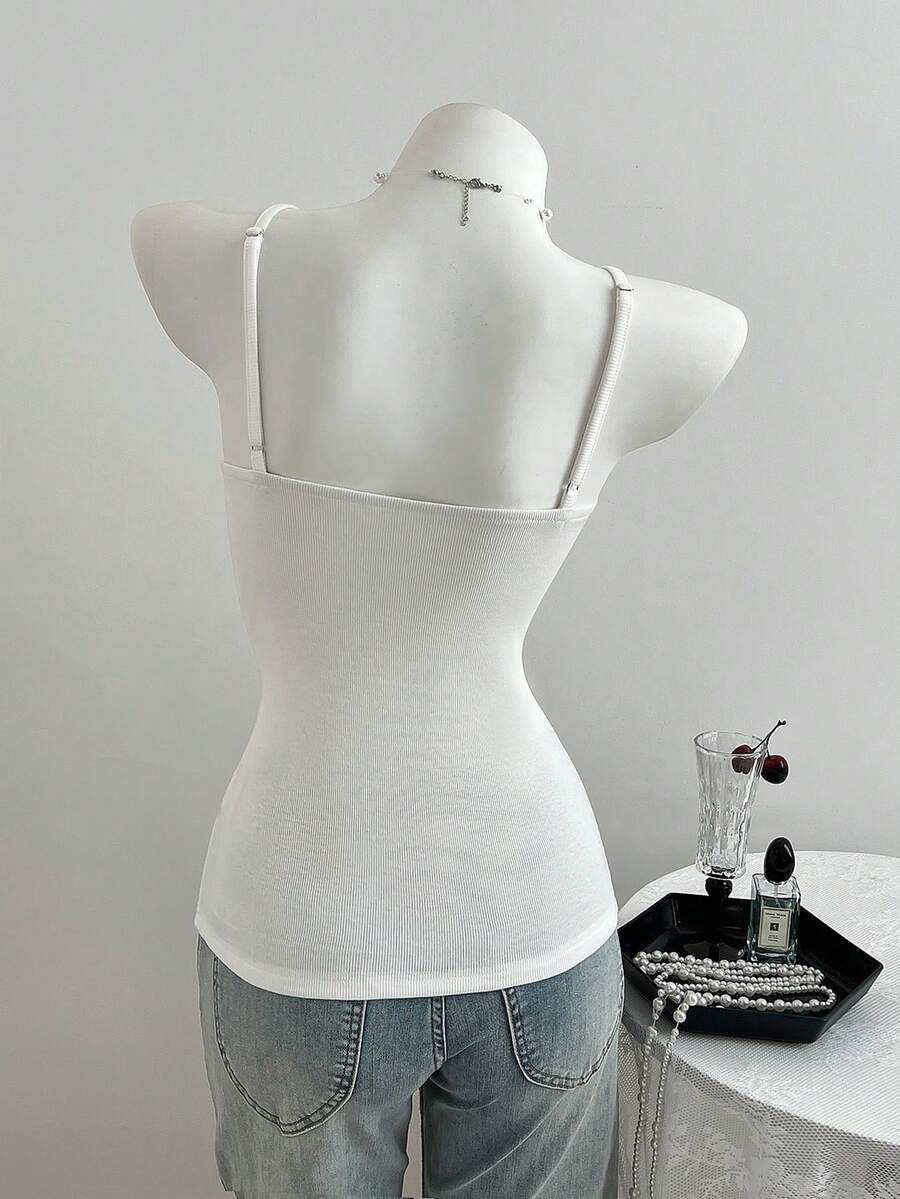 Women's slim fit backless cami tank top with contrast lace patchwork details, spaghetti straps, and high-stretch knitted ribbed fabric.