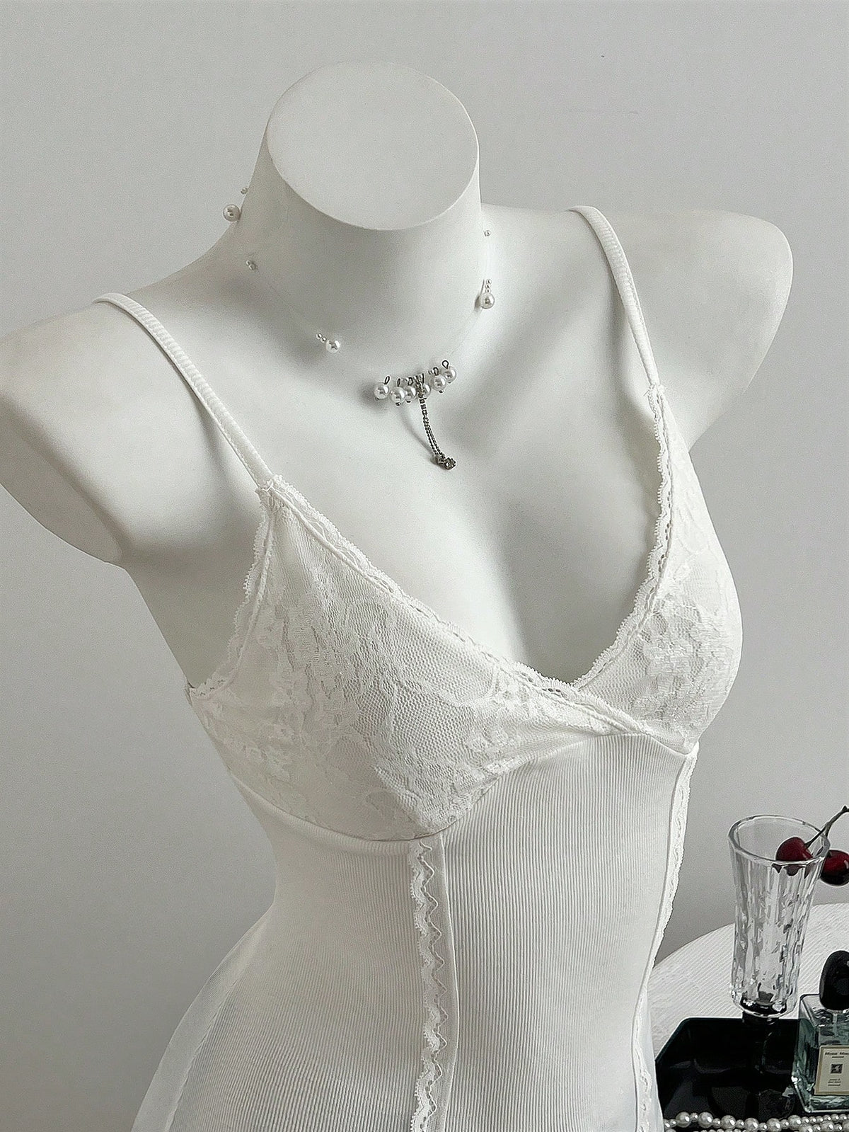 Women's slim fit backless cami tank top with contrast lace patchwork details, spaghetti straps, and high-stretch knitted ribbed fabric.