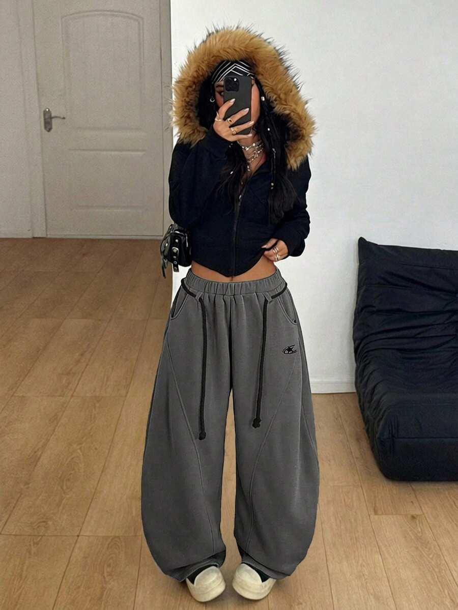 Women's casual grey plaid sweatpants featuring an elastic drawstring waistband, side pockets, and a relaxed loose fit.