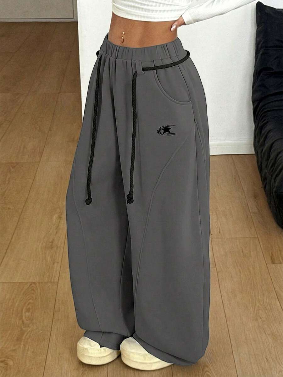 Women's casual grey plaid sweatpants featuring an elastic drawstring waistband, side pockets, and a relaxed loose fit.