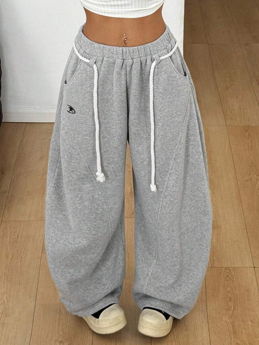 Plus size unisex baggy wide leg sweatpants in black with high elastic drawstring waist and side pockets