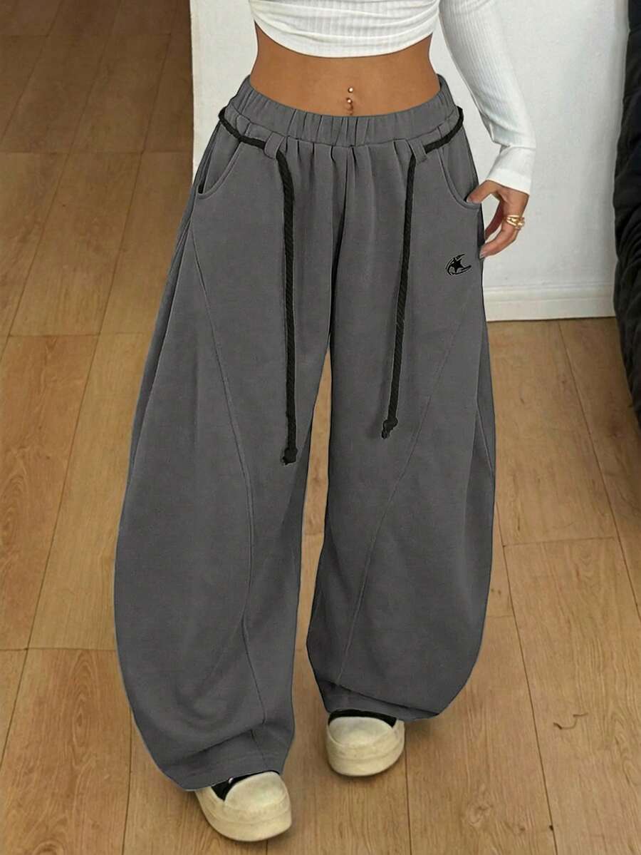 Women's casual grey plaid sweatpants featuring an elastic drawstring waistband, side pockets, and a relaxed loose fit.