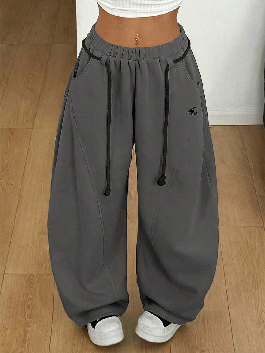 Women's casual grey plaid sweatpants featuring an elastic drawstring waistband, side pockets, and a relaxed loose fit.