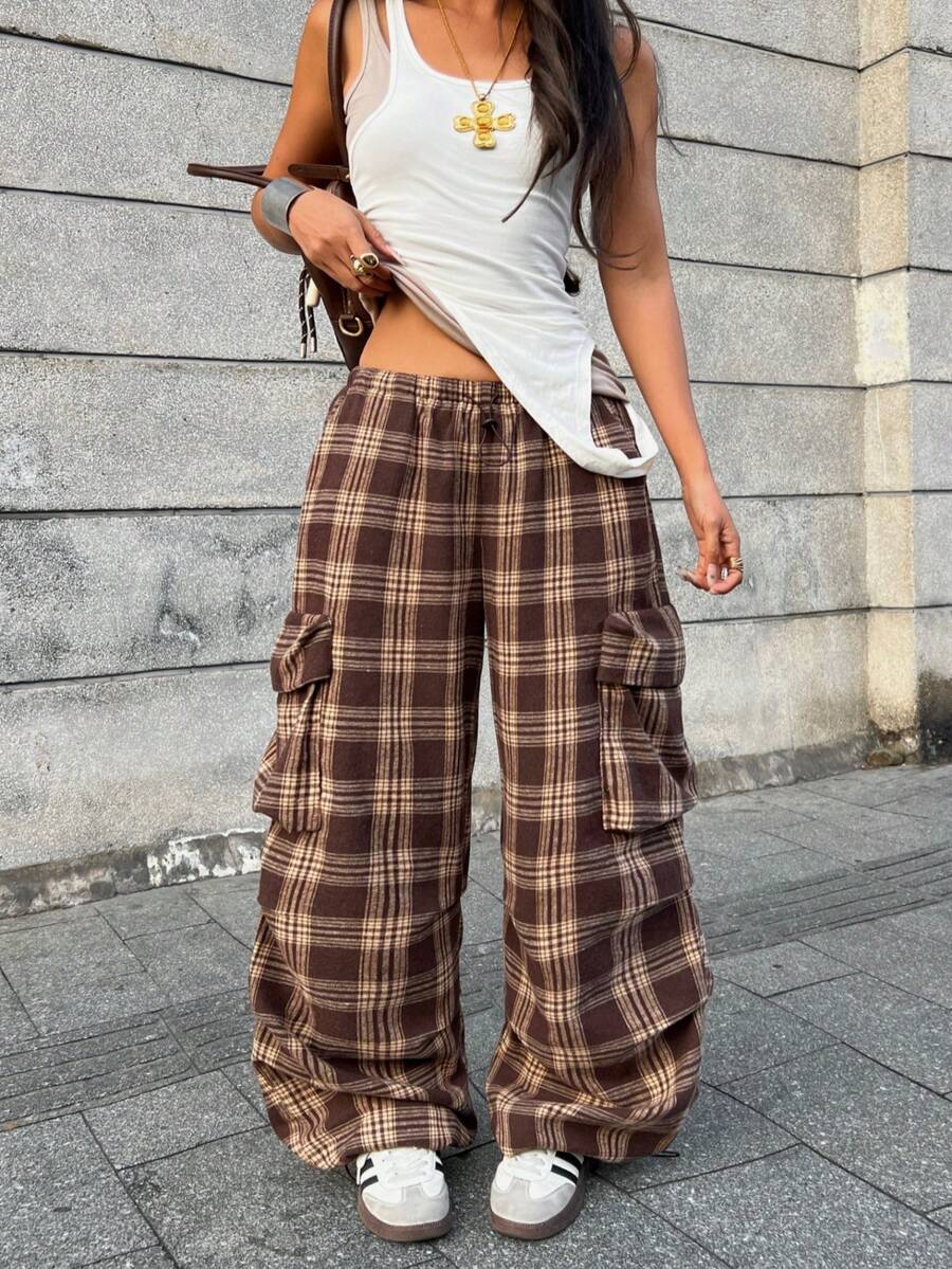 Women's loose fit parachute cargo pants featuring a drawstring waist and functional pockets in a casual streetwear style