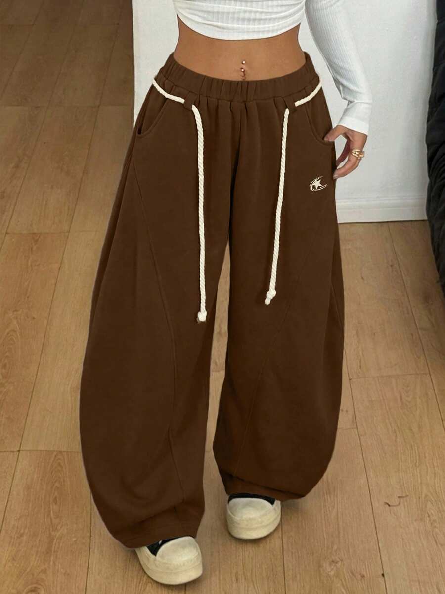 Women's casual grey plaid sweatpants featuring an elastic drawstring waistband, side pockets, and a relaxed loose fit.