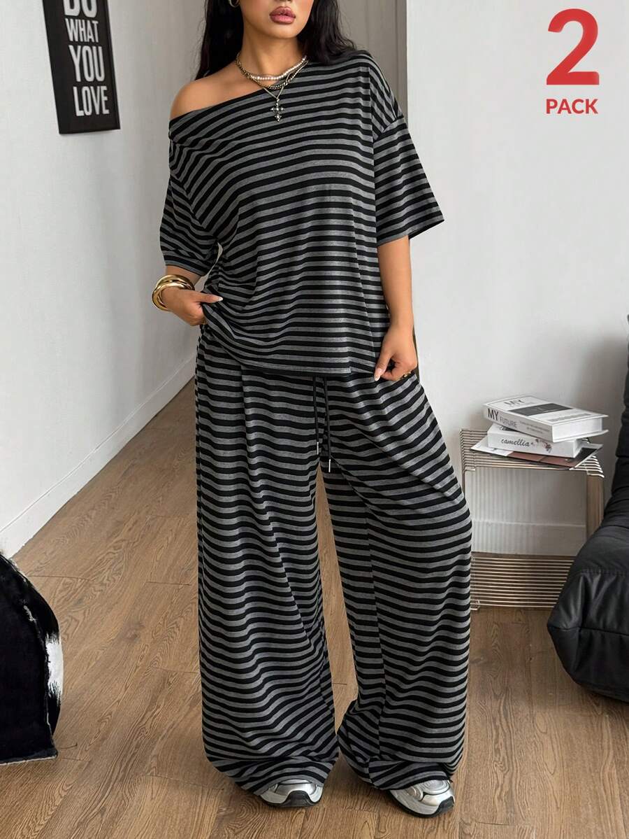 Women's casual two-piece outfit featuring a loose short-sleeve asymmetrical neck t-shirt and matching long wide leg pants with pockets.