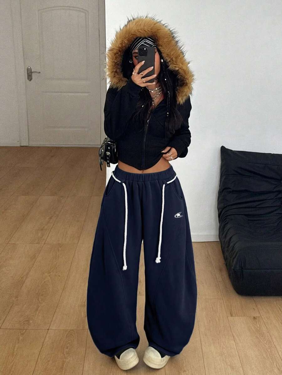 Women's casual grey plaid sweatpants featuring an elastic drawstring waistband, side pockets, and a relaxed loose fit.