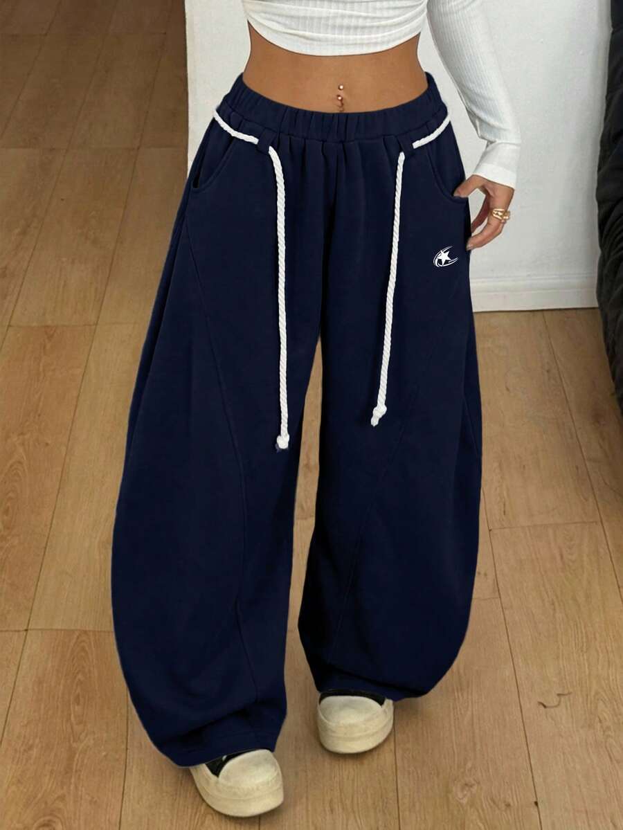 Women's casual grey plaid sweatpants featuring an elastic drawstring waistband, side pockets, and a relaxed loose fit.