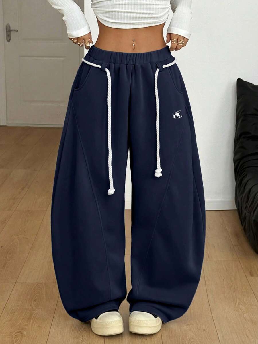 Women's casual grey plaid sweatpants featuring an elastic drawstring waistband, side pockets, and a relaxed loose fit.
