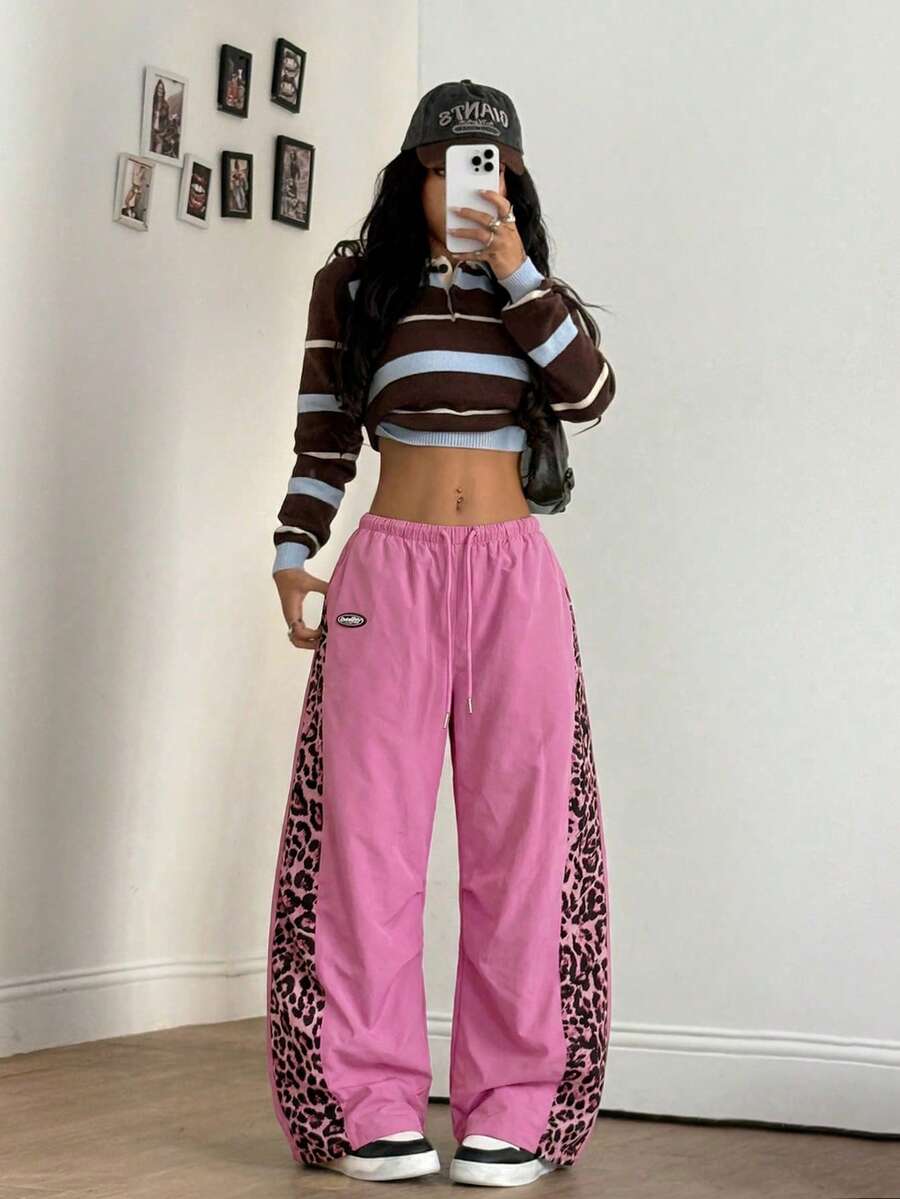 Women's black baggy jogger pants with an adjustable drawstring waist and colorblock polka dot geometric pattern.