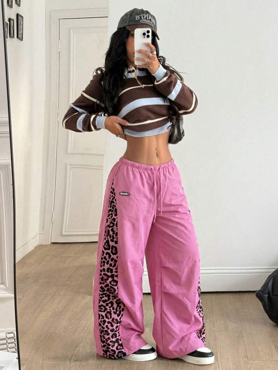 Women's black baggy jogger pants with an adjustable drawstring waist and colorblock polka dot geometric pattern.