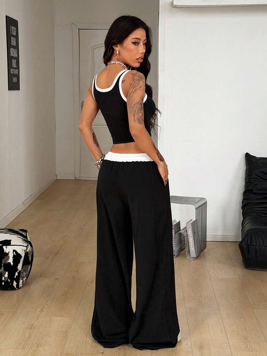 Women's black and white two-piece casual outfit featuring a colorblock notched camisole tank top and matching extra-long drawstring pants.