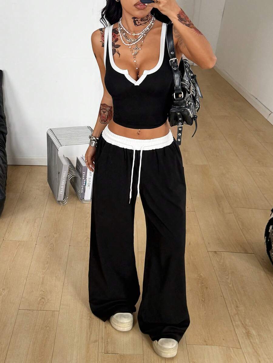 Women's black and white two-piece casual outfit featuring a colorblock notched camisole tank top and matching extra-long drawstring pants.