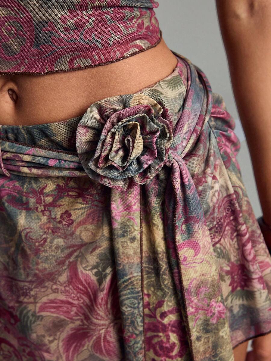 Multicolor two-piece outfit featuring a strapless bandeau top and a matching mesh mini skirt with zipper details.