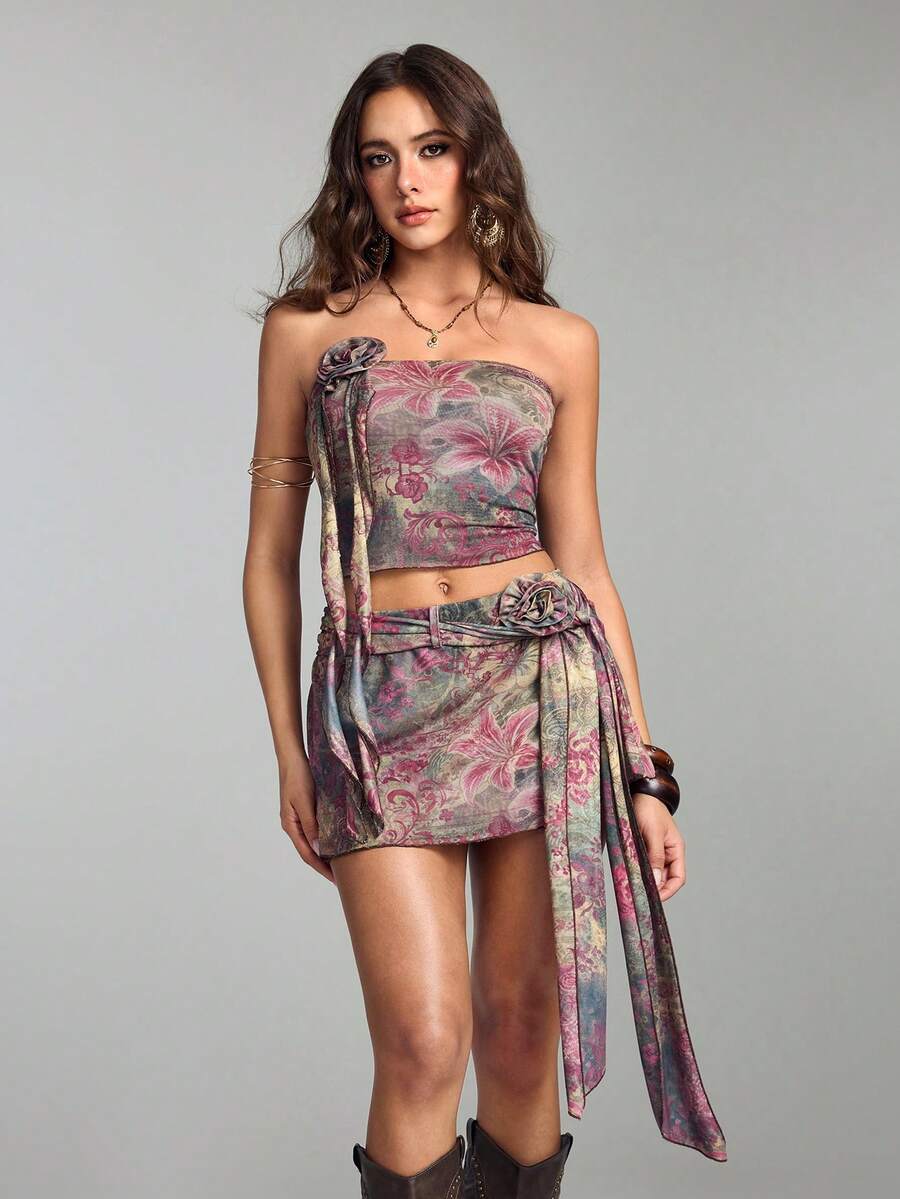 Multicolor two-piece outfit featuring a strapless bandeau top and a matching mesh mini skirt with zipper details.