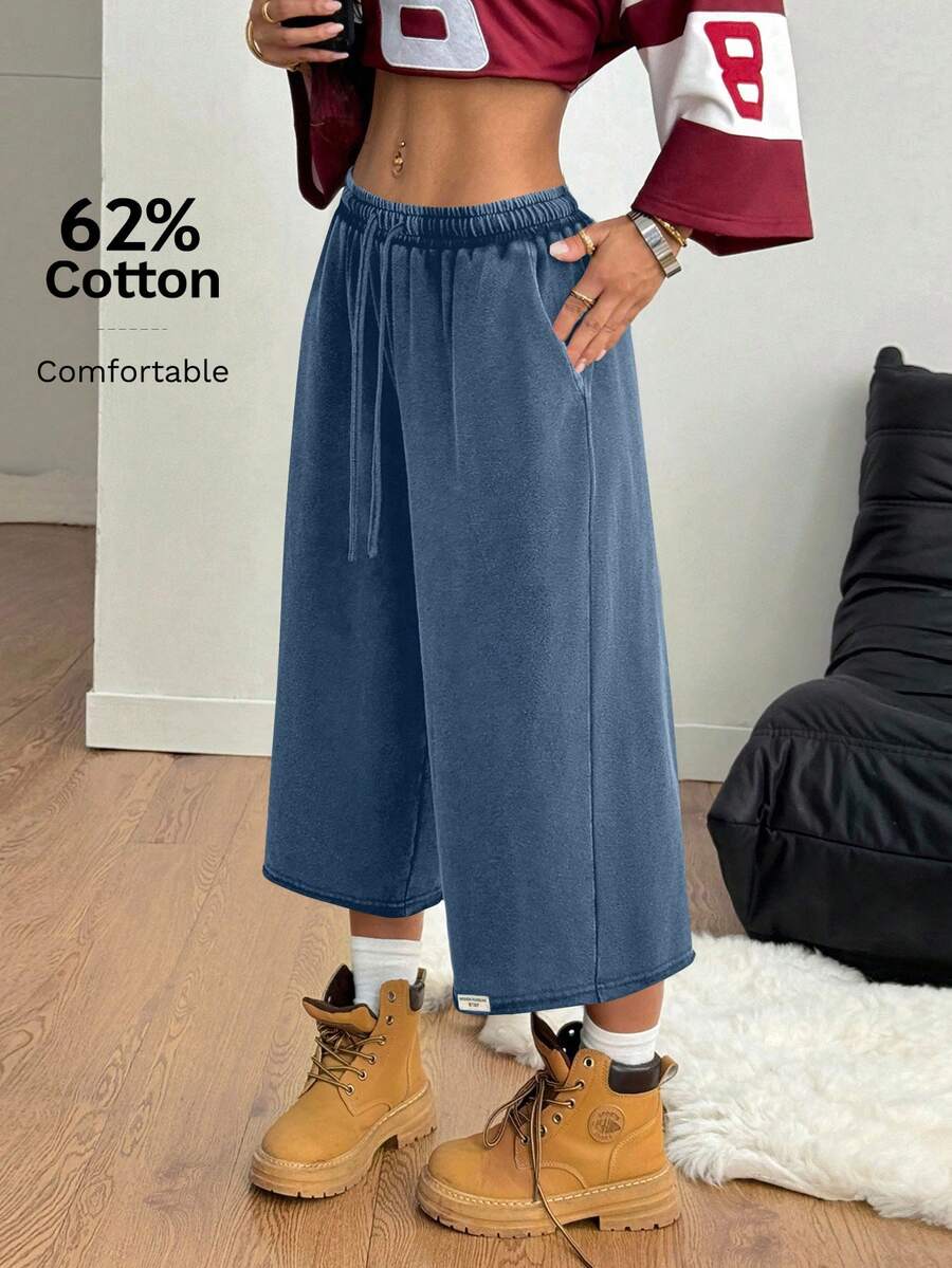 Women's loose-fit baggy Bermuda track shorts with an elastic drawstring waistband and side pockets.