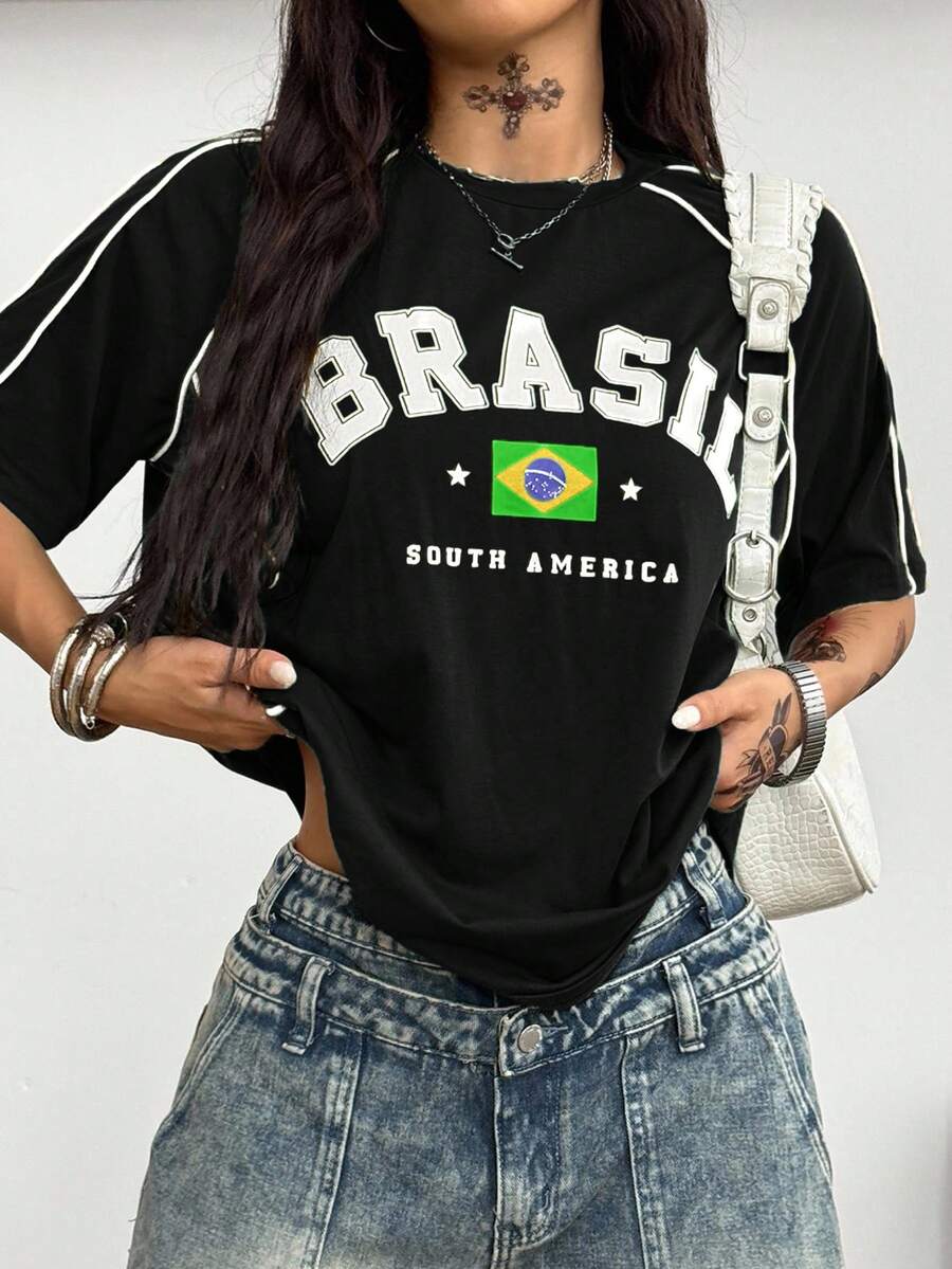 Yellow oversized graphic t-shirt featuring Brazil letter print on the front with contrast raglan sleeves and side stripe detailing.