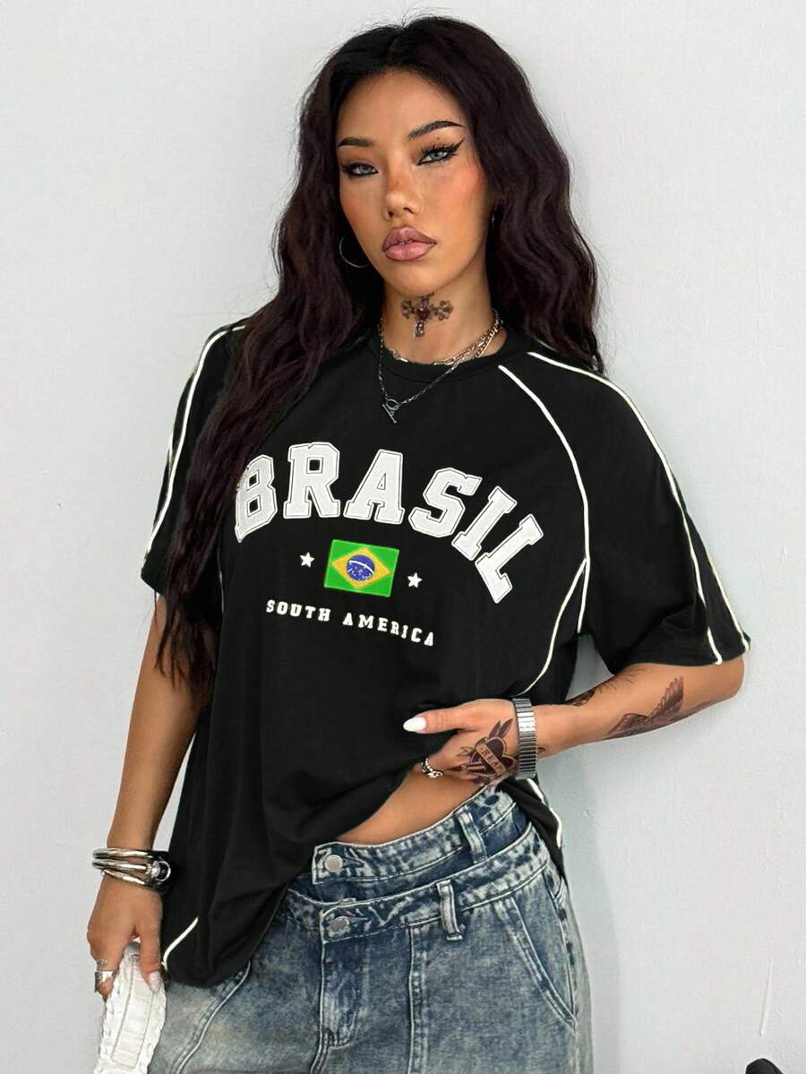 Yellow oversized graphic t-shirt featuring Brazil letter print on the front with contrast raglan sleeves and side stripe detailing.