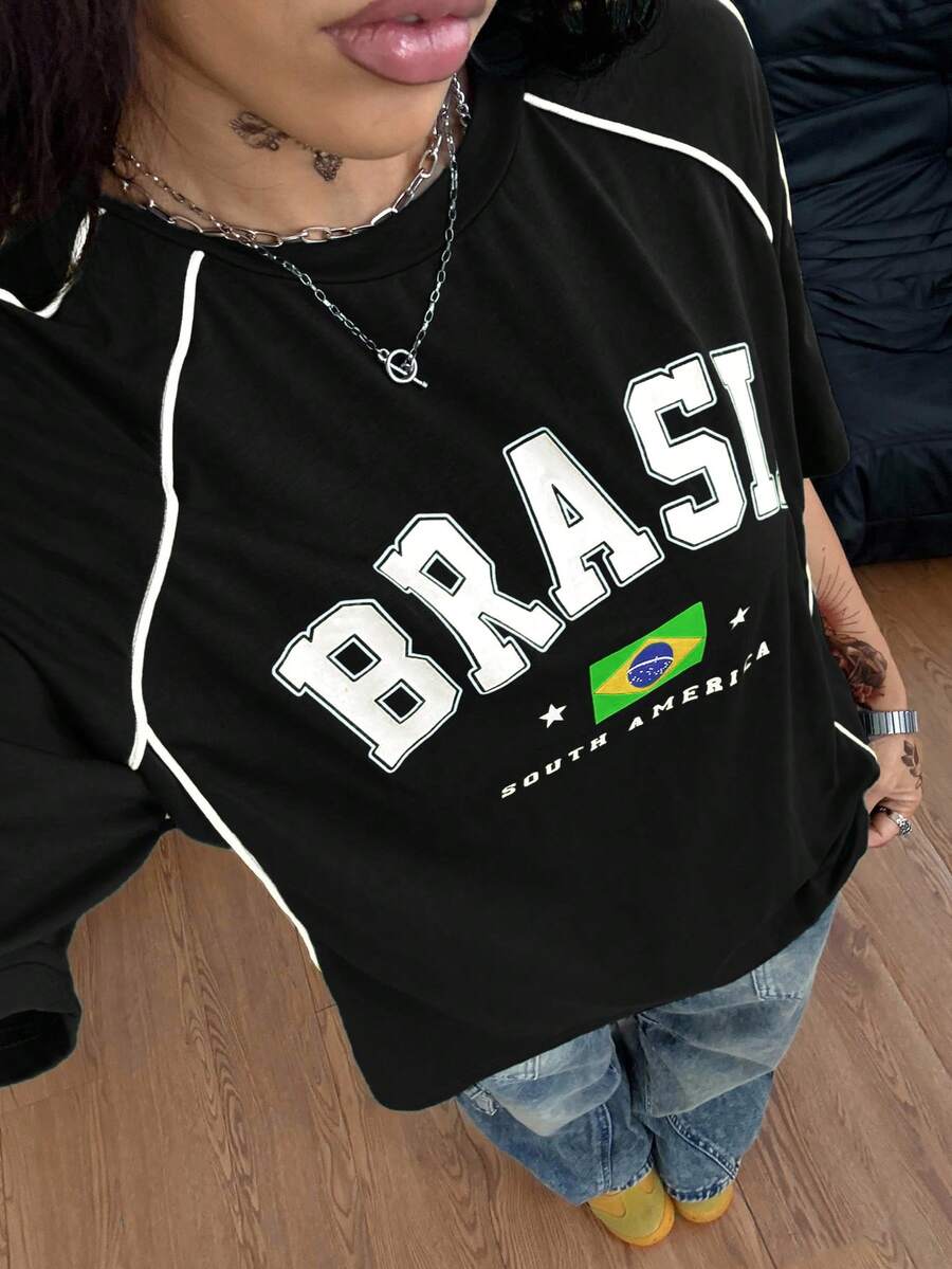 Yellow oversized graphic t-shirt featuring Brazil letter print on the front with contrast raglan sleeves and side stripe detailing.