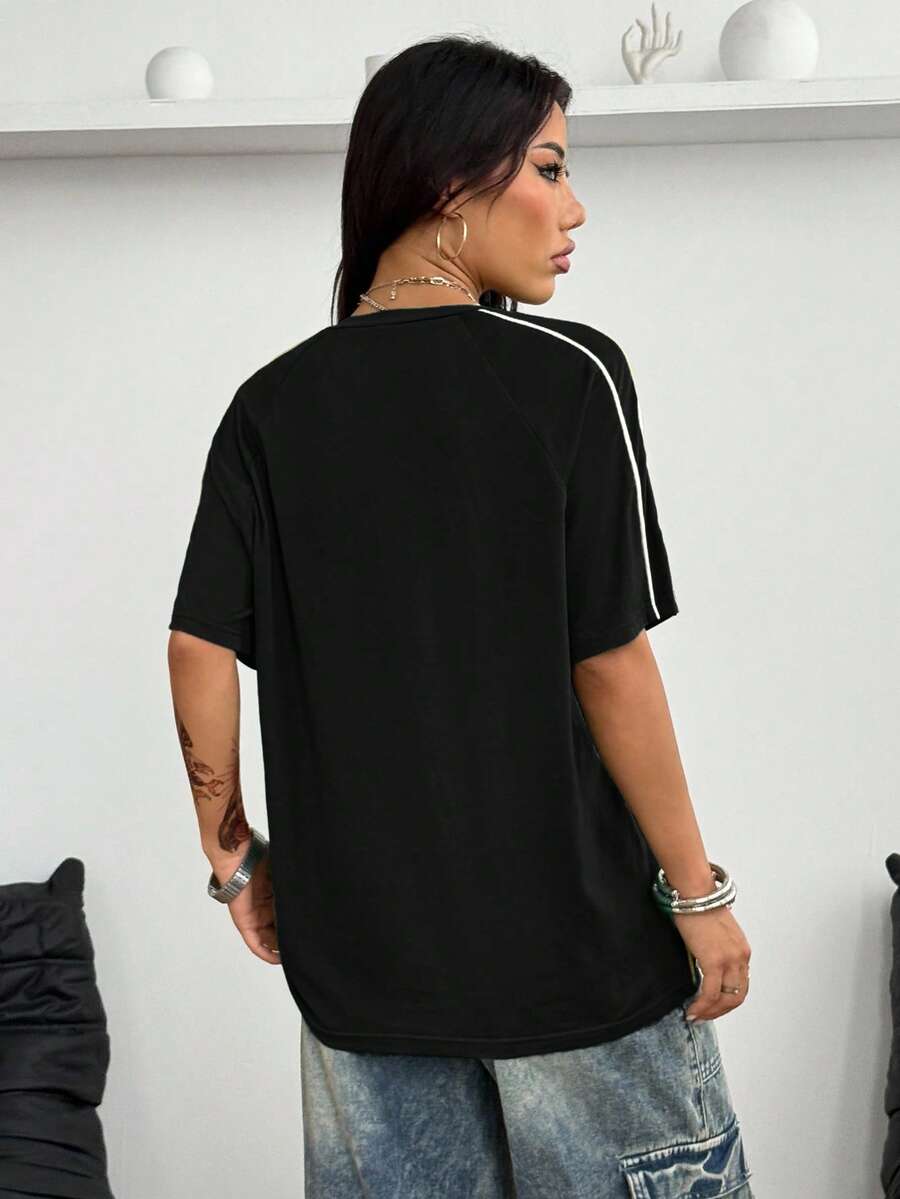 Yellow oversized graphic t-shirt featuring Brazil letter print on the front with contrast raglan sleeves and side stripe detailing.