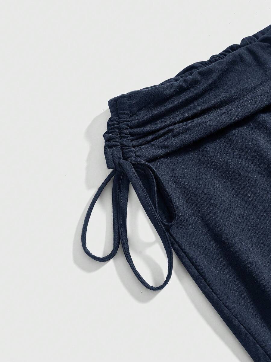 Women's low waist flare leg pants featuring an elastic drawstring waistband and ruched detail in knitted fabric.