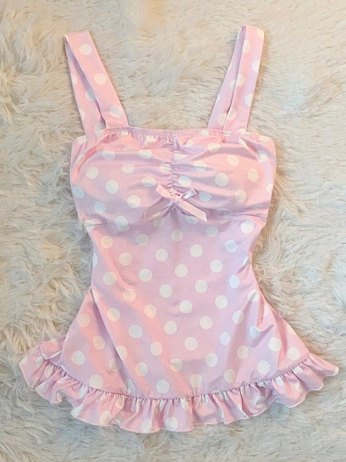 Women's retro slim-fit crop top featuring wide straps, ruched shirred detailing, asymmetrical ruffle hem, and cute bow accent.