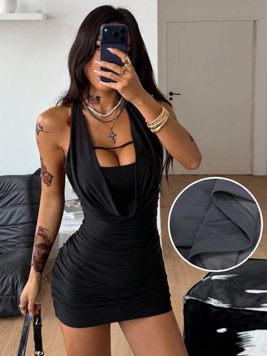 Woman wearing a black halter neck mesh bodycon mini dress featuring a backless tie-back design.