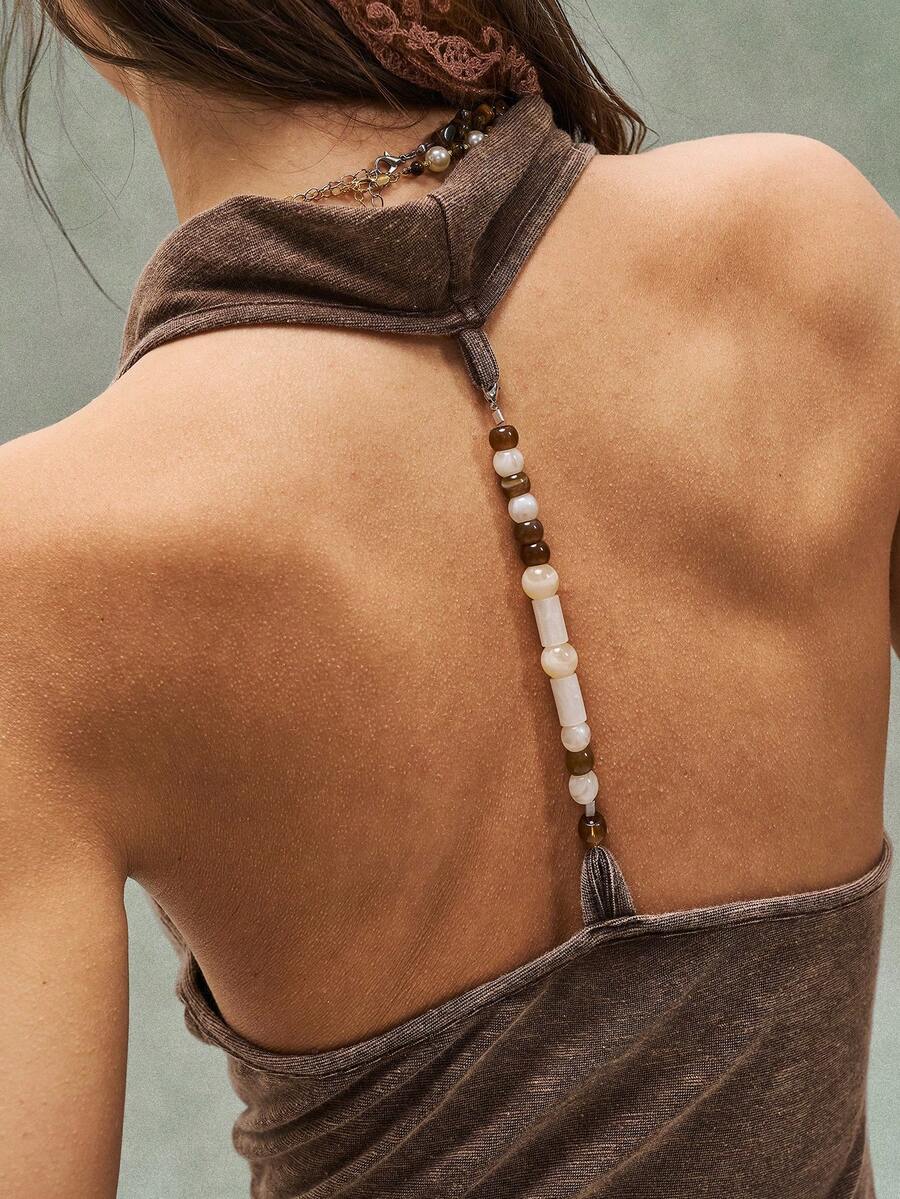 Women's casual solid color knit tank top with a backless halter neck design.