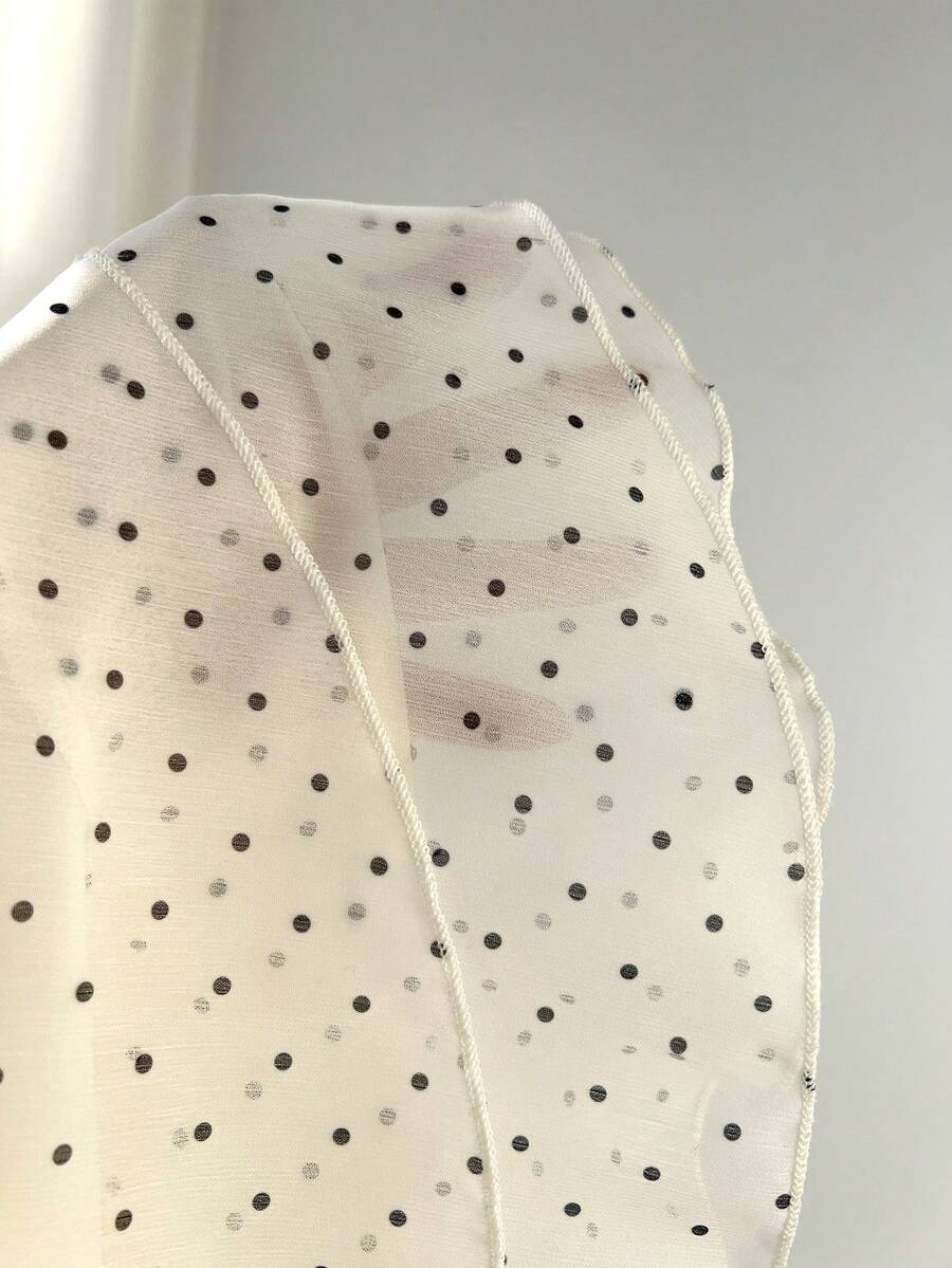 Women's white sleeveless halter neck top featuring pleated fabric, backless tie strap design, and a flared layered ruffle hem.