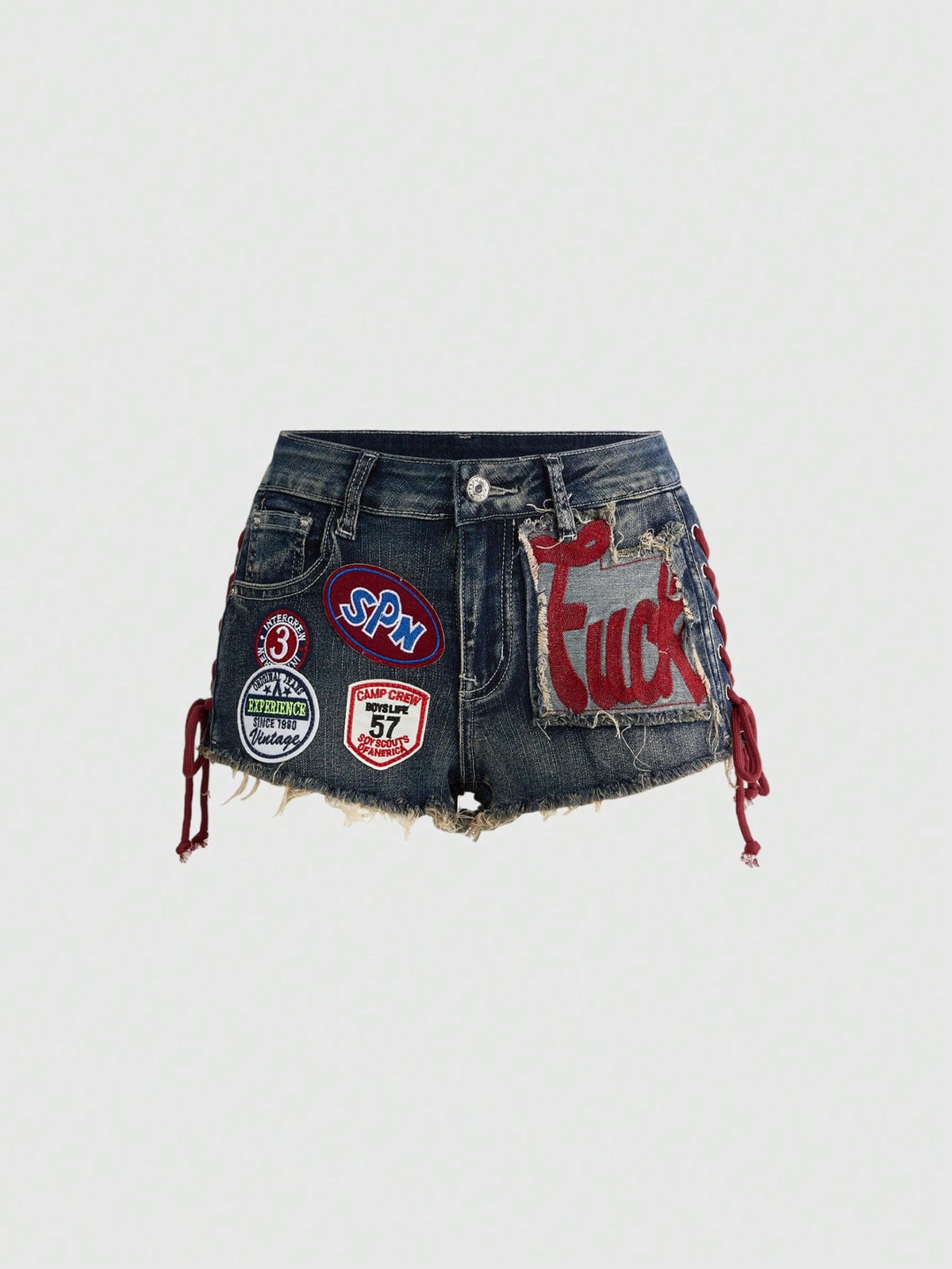 Women's Y2K low waist camo mini skort shorts featuring lace-up knot details, grommet eyelets, graphic lettering pattern, and a zipper fly.