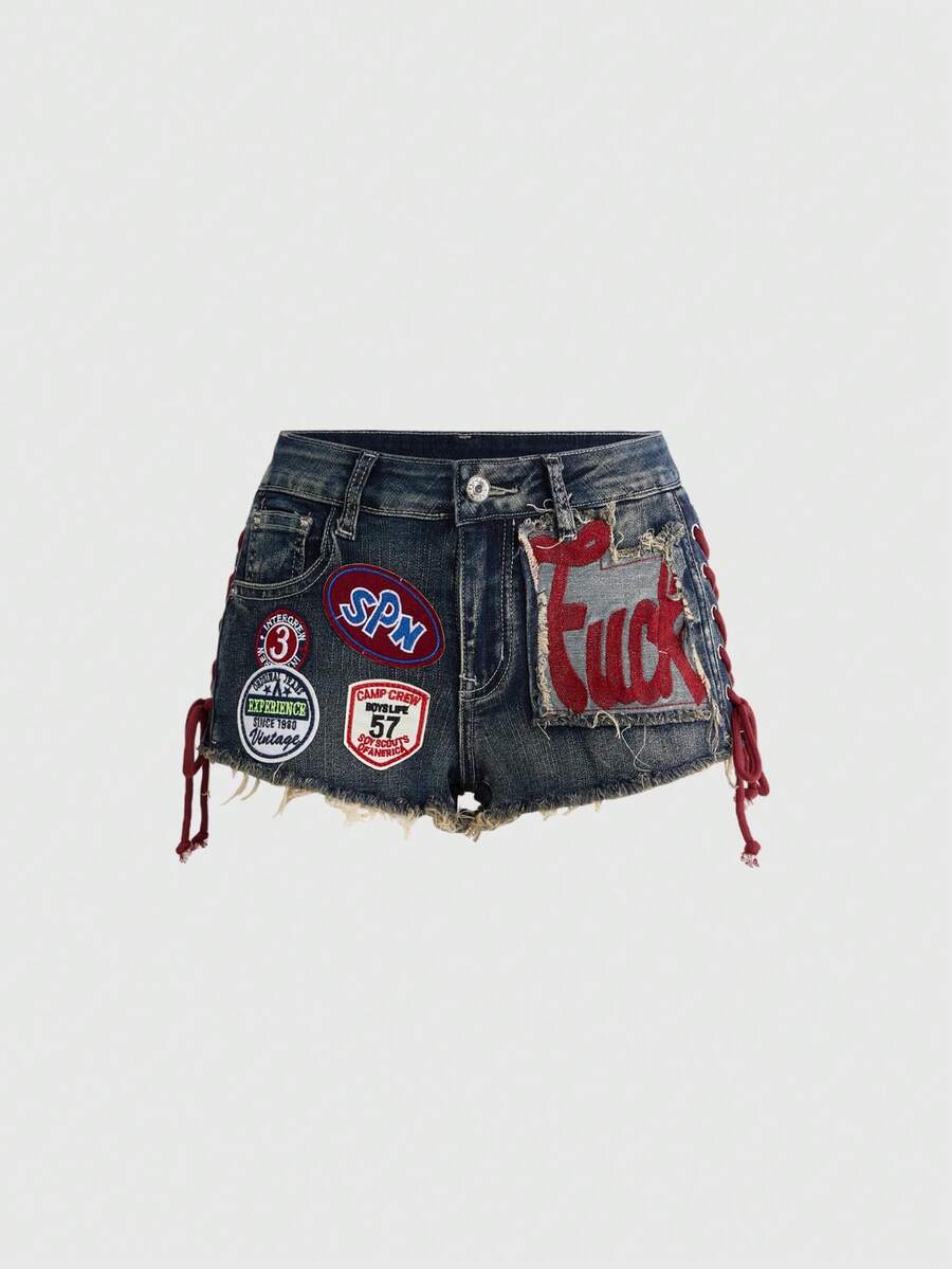 Women's Y2K low waist camo mini skort shorts featuring lace-up knot details, grommet eyelets, graphic lettering pattern, and a zipper fly.