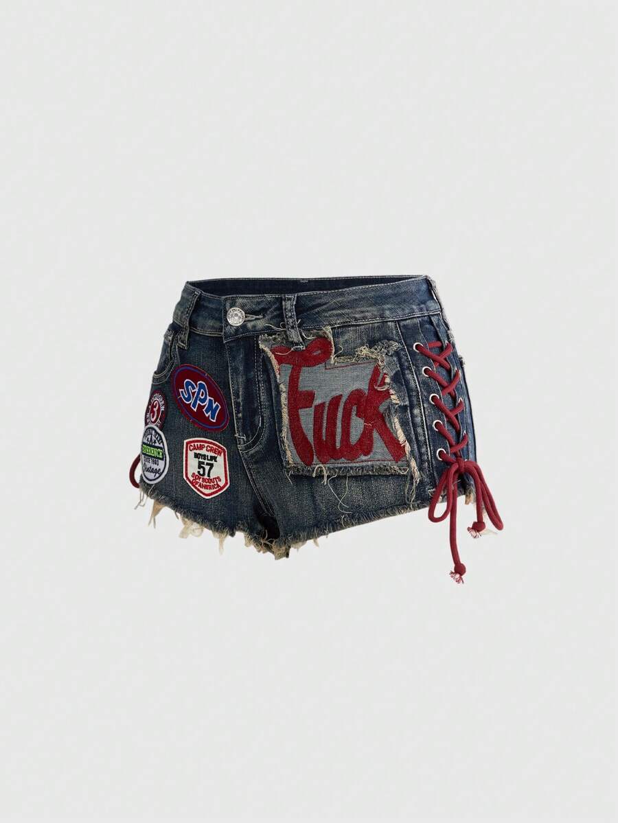 Women's Y2K low waist camo mini skort shorts featuring lace-up knot details, grommet eyelets, graphic lettering pattern, and a zipper fly.