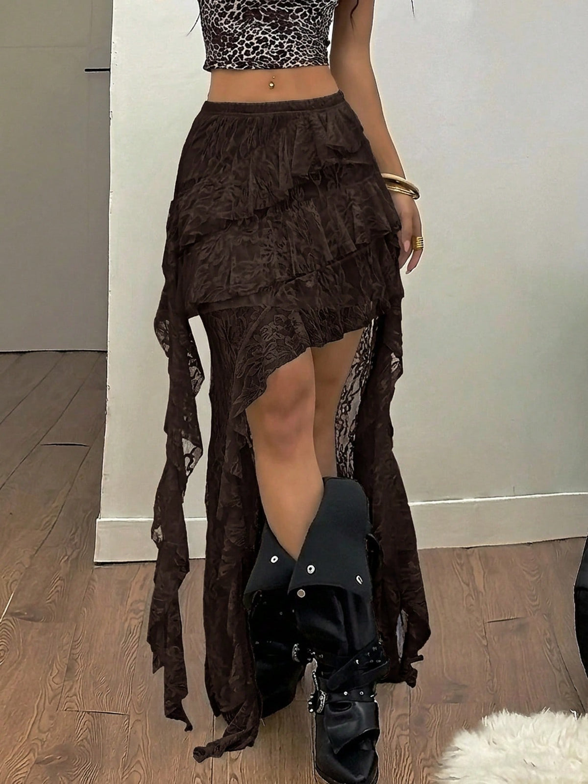 Women's low rise asymmetrical long skirt with ruffle hem detailing in semi-sheer knitted fabric.