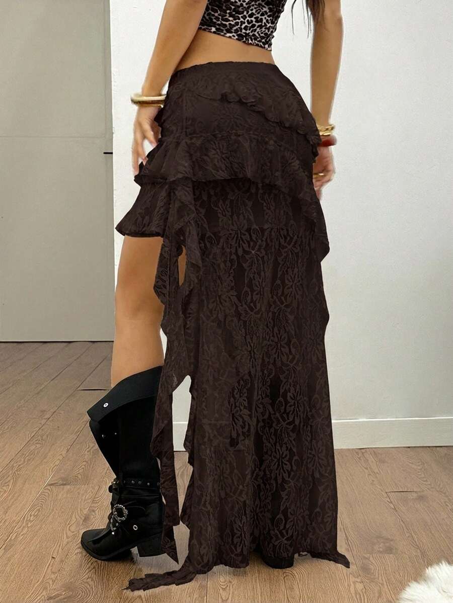 Women's low rise asymmetrical long skirt with ruffle hem detailing in semi-sheer knitted fabric.