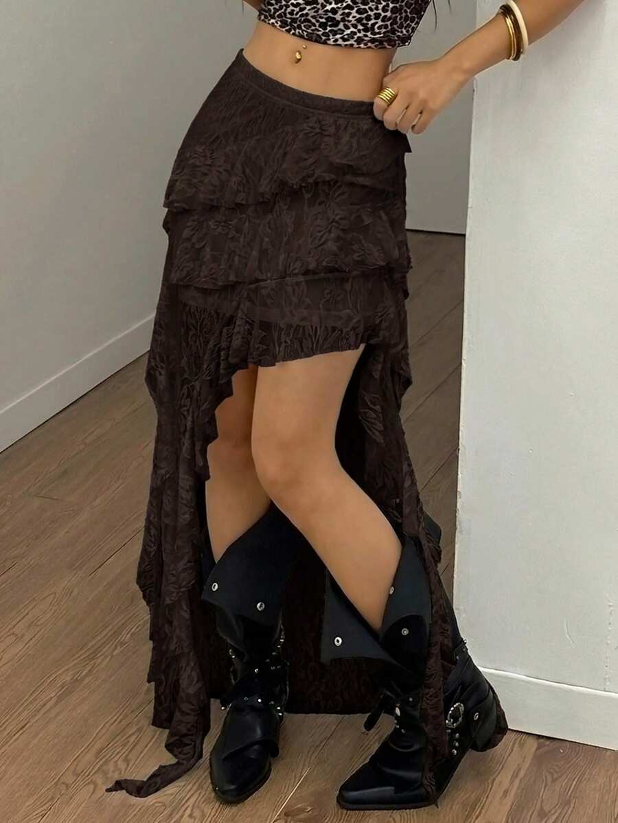 Women's low rise asymmetrical long skirt with ruffle hem detailing in semi-sheer knitted fabric.