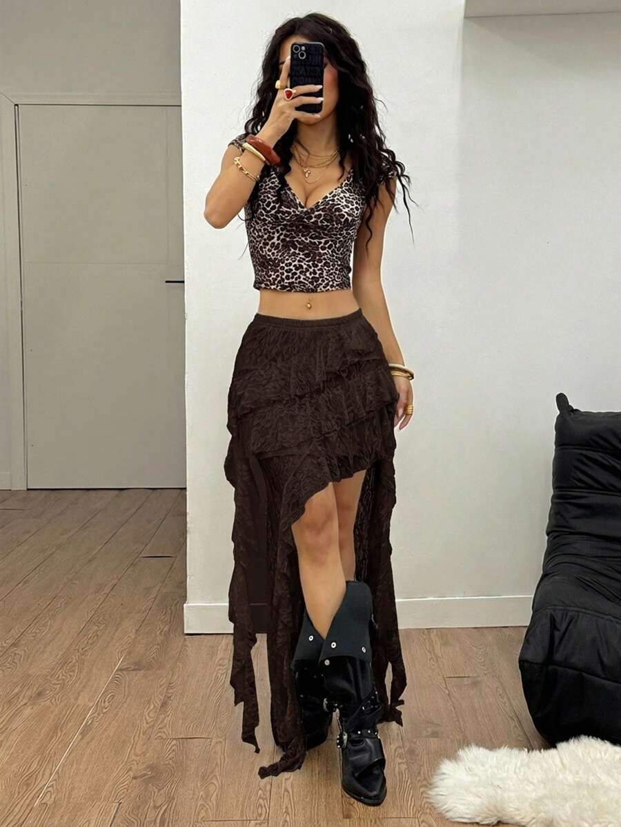 Women's low rise asymmetrical long skirt with ruffle hem detailing in semi-sheer knitted fabric.